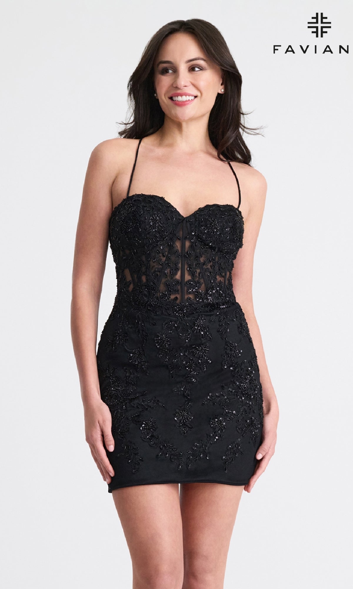 A woman stands smiling against a plain background in a fitted black, strapless dress with beaded details. The “FAVIAN” logo appears at the top right. Inspired by the Strappy-Back Short Lace Hoco Dress: Faviana 11301’s open-back design.